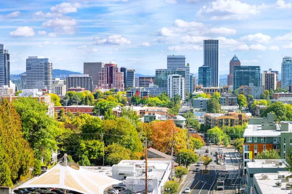 View of Portland skyline with green trees in foreground.